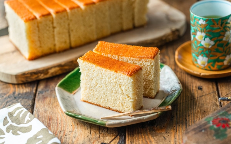 An octagon plate containing two slices of Castella cake.
