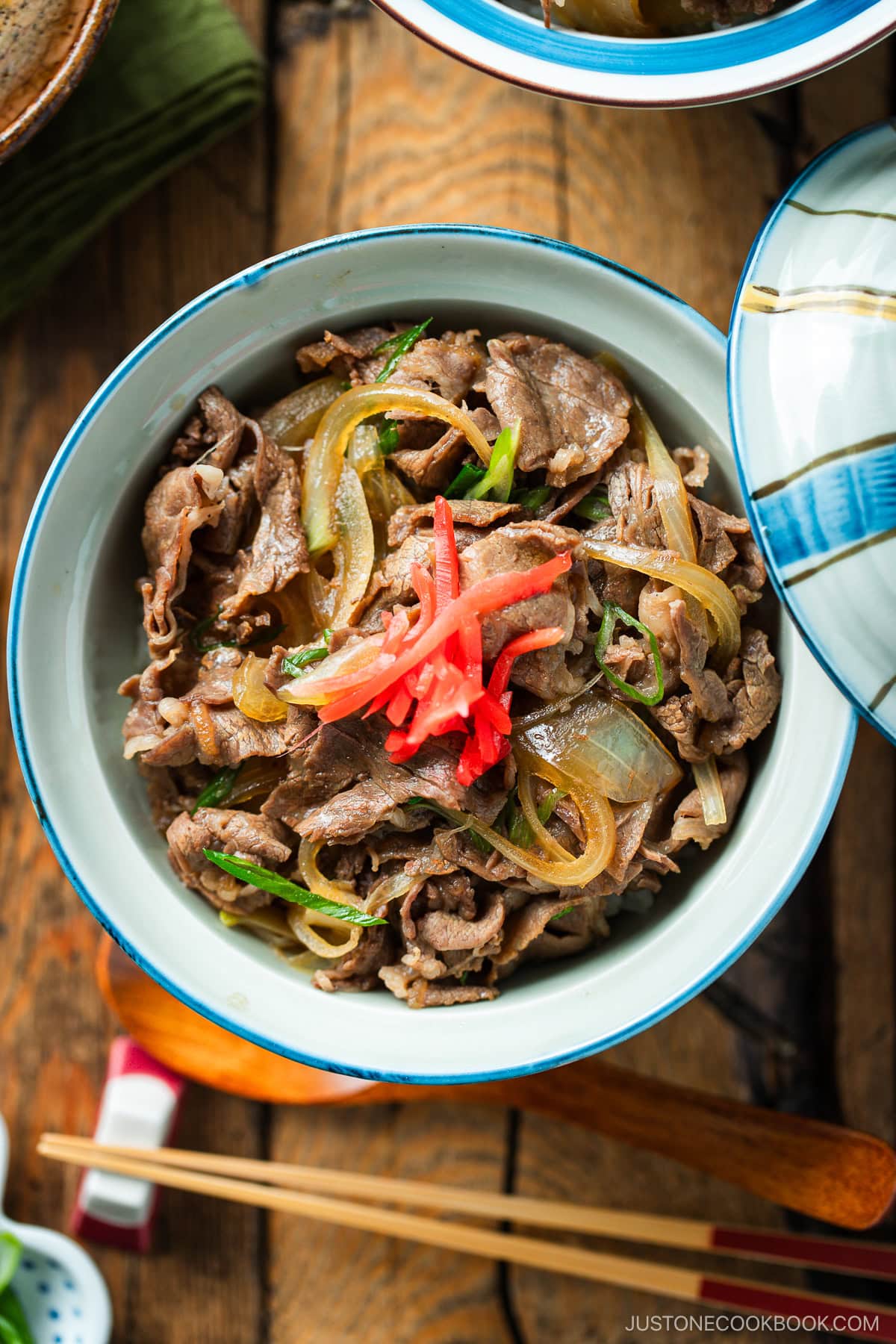 Donburi rice bowls containing gyudon, simmered beef and onions over steamed rice.