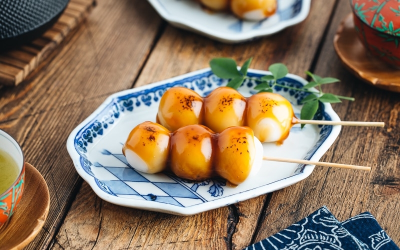 Mitarashi Dango on a blue plate.